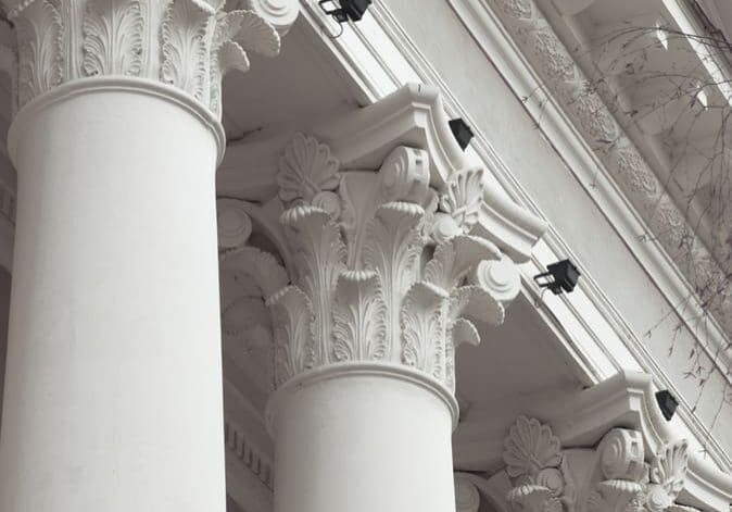 A close up of three pillars with lights on them