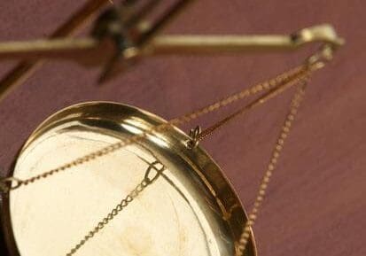 A close up of a mirror with chains hanging from it